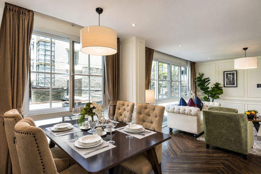 Open plan living and dining room with herringbone floors at The Elite Thong Lor 25