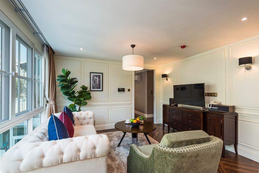 The living room seen from the dining end, with a smart television