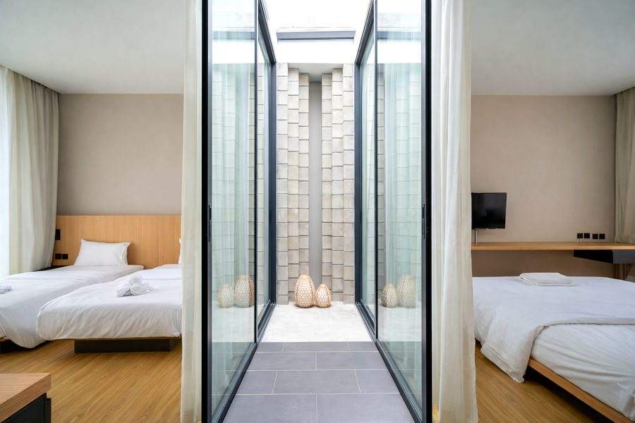 Both bedrooms at The Elite @ Pattaya seen across the glass light well that separates them