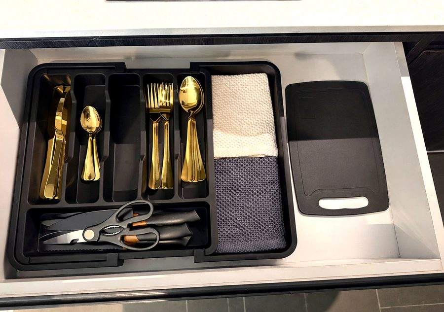 A drawer of gold cutlery, kitchen scissors and cloths at The Elite @ Pattaya