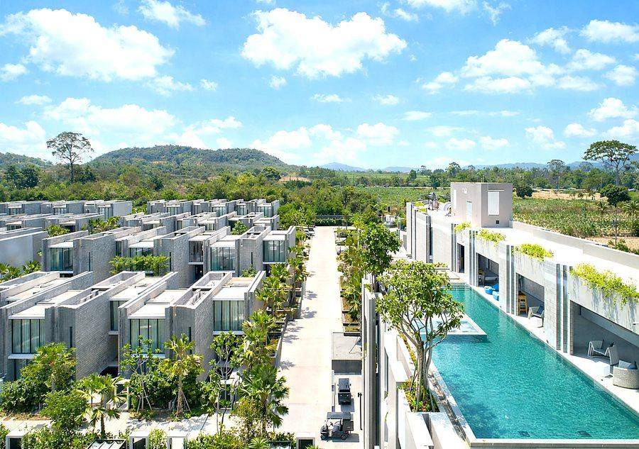 An aerial view of the Oceanphere development at Bang Sare, with rows of grey brick villas along a long communal pool